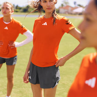 Athletes wearing orange team apparel outdoors
