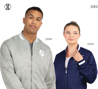 A man wears a light gray V-STREET FULL-ZIP JACKET, standing beside a woman in a navy blue ladies' fit jacket with striped rib-knit trim. Both look slightly off-camera with neutral expressions.