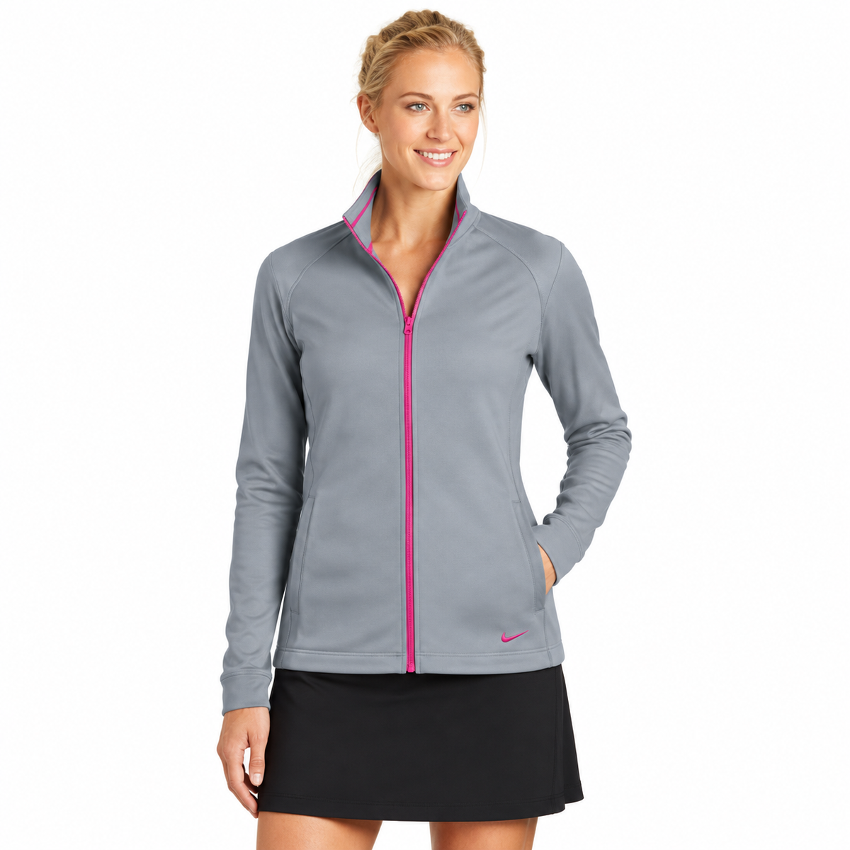 Model wearing light-gray Nike Therma-FIT full-zip jacket with pink zipper